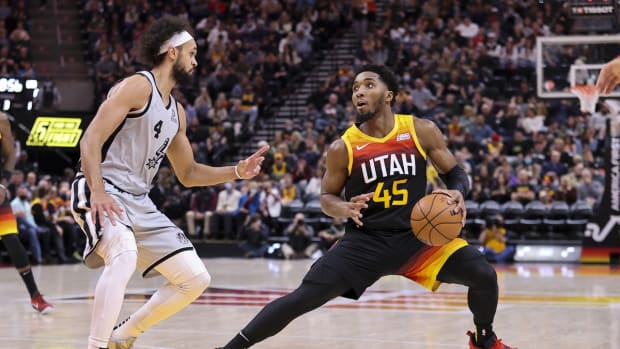 Dec 17, 2021; Salt Lake City, Utah, USA; Utah Jazz guard Donovan Mitchell (45) steps back to shot the ball over San Antonio Spurs guard Derrick White (4) in the third quarter at Vivint Arena. Mandatory Credit: Rob Gray-USA TODAY Sports